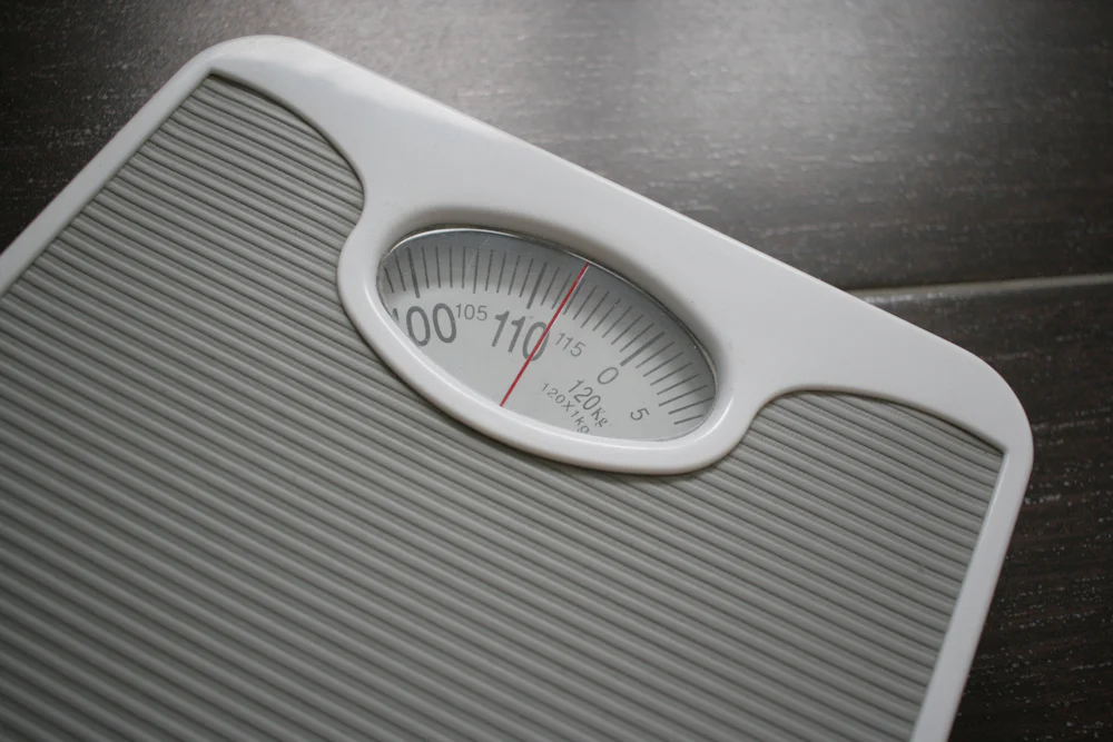 A set of bathroom scales on a tiled floor